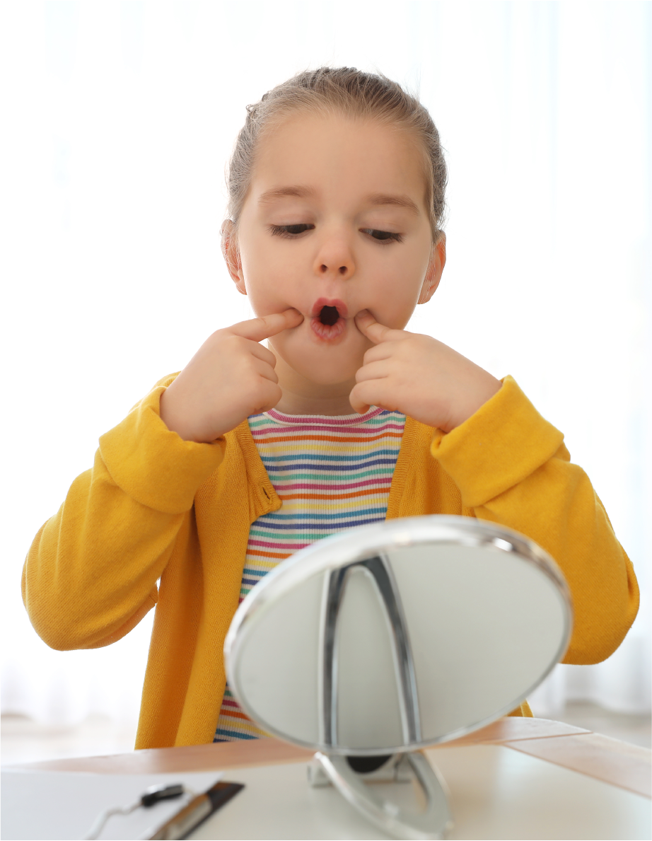 Girl making shapes with her mouth in the mirror